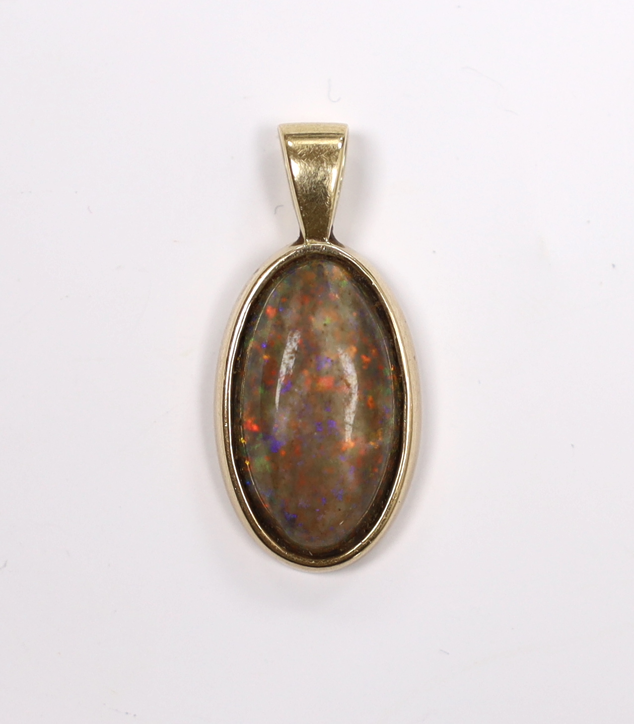 A yellow metal mounted oval black opal pendant, overall 30mm, gross weight 4 grams.